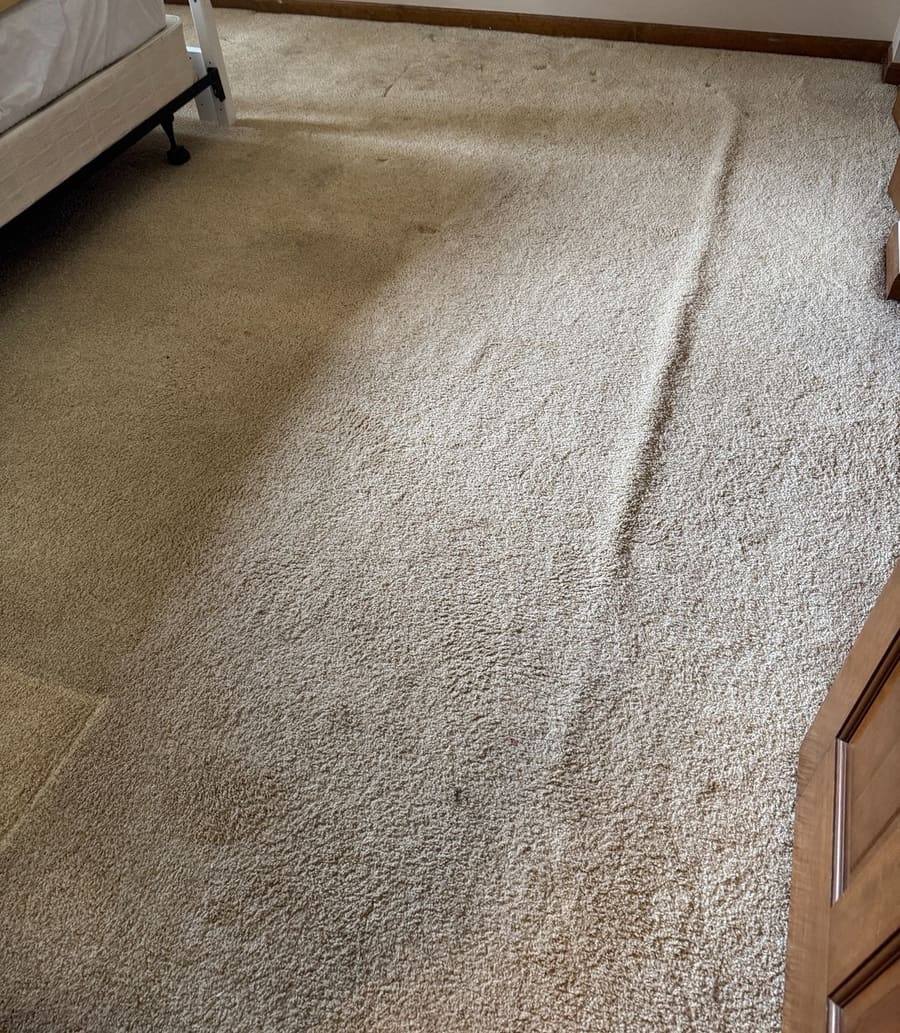 Before: Before cleaning: bedroom carpet with visible traffic soil near the bed